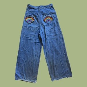 Lazy Oaf blue jeans with heart-shaped back pockets and rainbow embroidery